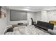 Spacious finished basement featuring a large screen television, a mini refrigerator, and gray floors at 657 Polk Nw St, Marietta, GA 30064