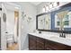 Bathroom featuring a double vanity with wood cabinets, and a tiled shower and bathtub combo at 657 Polk Nw St, Marietta, GA 30064
