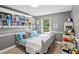 Cozy bedroom featuring a twin bed, built-in shelves, and a sunlit window at 657 Polk Nw St, Marietta, GA 30064