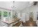 Bright dining area features large windows, hardwood floors, modern chandelier, and rustic farmhouse furniture at 657 Polk Nw St, Marietta, GA 30064