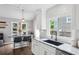 Bright kitchen featuring a marble breakfast bar, updated appliances, and a large picture window above the sink at 657 Polk Nw St, Marietta, GA 30064