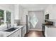Modern kitchen features gray stone countertops, new appliances, diamond-shaped windows and black hardware at 657 Polk Nw St, Marietta, GA 30064
