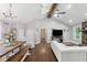 Open-concept living room with vaulted ceilings, hardwood floors, a fireplace, and plenty of natural light at 657 Polk Nw St, Marietta, GA 30064