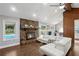 Open-concept living room features a stone fireplace, vaulted ceilings, backyard pool access, and hardwood floors at 657 Polk Nw St, Marietta, GA 30064