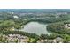 Aerial showcasing lake and community with trees and houses at 702 Crescent Cir, Canton, GA 30115