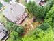 Aerial view of home with a spacious deck overlooking landscaped gardens and mature trees at 702 Crescent Cir, Canton, GA 30115