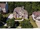 Aerial view of a traditional brick home showcasing its manicured lawn and lush surroundings at 702 Crescent Cir, Canton, GA 30115