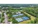 Expansive aerial view of the community showcasing the lake, pool, and tennis courts in a lush setting at 702 Crescent Cir, Canton, GA 30115