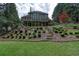 Spacious backyard with layered landscaping and multi-tiered deck and patio at 702 Crescent Cir, Canton, GA 30115