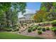 Beautiful backyard landscape with stone steps and tiered garden area at 702 Crescent Cir, Canton, GA 30115