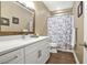 Bathroom featuring a white vanity and marble shower curtain, exuding modern style at 702 Crescent Cir, Canton, GA 30115