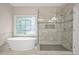 Freestanding tub next to a modern, tiled walk-in shower at 702 Crescent Cir, Canton, GA 30115