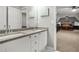 Bathroom featuring a granite-topped vanity with double sinks and a view into a bedroom at 702 Crescent Cir, Canton, GA 30115