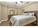 Cozy bedroom with wood floors, a ceiling fan, and a well-dressed bed and dresser at 702 Crescent Cir, Canton, GA 30115