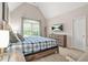 Cozy bedroom features carpeted floors, vaulted ceiling, TV, and a large window for plenty of natural light at 702 Crescent Cir, Canton, GA 30115