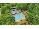 Aerial view of a community pool surrounded by mature trees and outdoor seating areas at 702 Crescent Cir, Canton, GA 30115
