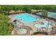 Community pool with lounge chairs, tables, water features and surrounding tennis courts at 702 Crescent Cir, Canton, GA 30115