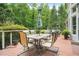 Outdoor deck with dining table and chairs overlooking lush greenery at 702 Crescent Cir, Canton, GA 30115