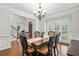 Elegant dining room with wood table and chairs, stylish light fixture, and neutral wall color at 702 Crescent Cir, Canton, GA 30115