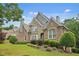 Charming two-story home with brick and stone exterior and well-maintained lawn at 702 Crescent Cir, Canton, GA 30115