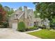 Attractive two-story home with brick and stone accents, attached garage and long driveway at 702 Crescent Cir, Canton, GA 30115