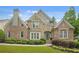 Stunning two-story brick and stone home with manicured landscaping at 702 Crescent Cir, Canton, GA 30115