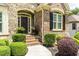 Inviting front entrance featuring brick steps, decorative plants, and elegant door design at 702 Crescent Cir, Canton, GA 30115