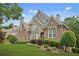 Exterior home view showcases a well-maintained lawn and lush greenery at 702 Crescent Cir, Canton, GA 30115
