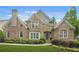 Beautiful brick and stone home featuring manicured landscaping and a charming front entrance at 702 Crescent Cir, Canton, GA 30115