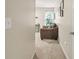 Hallway with carpeted floors leads to a sitting area with a large chair and a window at 702 Crescent Cir, Canton, GA 30115