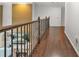 Second floor hallway with a hardwood floor and a decorative iron banister at 702 Crescent Cir, Canton, GA 30115