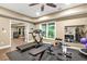 Spacious home gym with a treadmill, weight bench, and large window view at 702 Crescent Cir, Canton, GA 30115