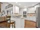 Bright, open kitchen featuring stainless steel appliances, granite countertops, and a breakfast bar with seating at 702 Crescent Cir, Canton, GA 30115