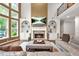 Inviting living room featuring a stone fireplace, built-in shelves, and comfortable leather seating at 702 Crescent Cir, Canton, GA 30115