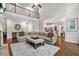 Spacious living room with high ceilings, fireplace, hardwood floors and a large comfortable sectional sofa at 702 Crescent Cir, Canton, GA 30115