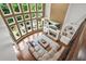Bright living room boasts hardwood floors, a stone fireplace, built-in shelves, and a wall of windows at 702 Crescent Cir, Canton, GA 30115