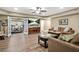 Open-concept living room with wood-look floors, a television, and a separate exercise area at 702 Crescent Cir, Canton, GA 30115