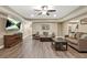 Spacious living room, light-colored walls, recessed lights and wood-look floors and a television at 702 Crescent Cir, Canton, GA 30115