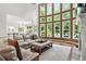 Sun-filled living room with a large window, a comfortable leather sofa, and neutral decor at 702 Crescent Cir, Canton, GA 30115