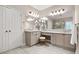 A main bathroom featuring and sinks, large mirrors with candle decor, and a separate toilet area at 702 Crescent Cir, Canton, GA 30115
