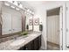 Bathroom features a granite countertop, dual sinks, framed mirrors, and a shower with curtain at 1417 Woodrow Kay Rd, Rockmart, GA 30153