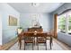 Traditional dining room features natural light, a wood table with seating for four and beautiful decor elements at 1417 Woodrow Kay Rd, Rockmart, GA 30153