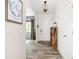 Bright entryway with wood-look flooring, decorative light fixture, and an arched doorway leading to other rooms at 1417 Woodrow Kay Rd, Rockmart, GA 30153