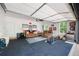 Well-lit garage with a large roll-up door, seating, storage, and access to the outdoors at 1417 Woodrow Kay Rd, Rockmart, GA 30153