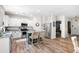 The open kitchen has white cabinets, stainless steel appliances, and a peninsula with barstool seating at 1417 Woodrow Kay Rd, Rockmart, GA 30153