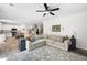 An open living room features wood floors, a large sectional sofa, with a view of the kitchen at 1417 Woodrow Kay Rd, Rockmart, GA 30153