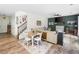 An open-concept living room with dining area, staircase and a large sofa creates a cozy and inviting space at 1417 Woodrow Kay Rd, Rockmart, GA 30153