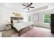 Serene main bedroom with tray ceiling, large windows, and neutral decor at 1417 Woodrow Kay Rd, Rockmart, GA 30153