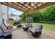 Inviting outdoor space with covered patio, seating, fire pit, and lush greenery at 1417 Woodrow Kay Rd, Rockmart, GA 30153