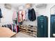 Walk-in closet featuring custom shelving, hanging racks, and a Sentry safe for secure storage at 1417 Woodrow Kay Rd, Rockmart, GA 30153